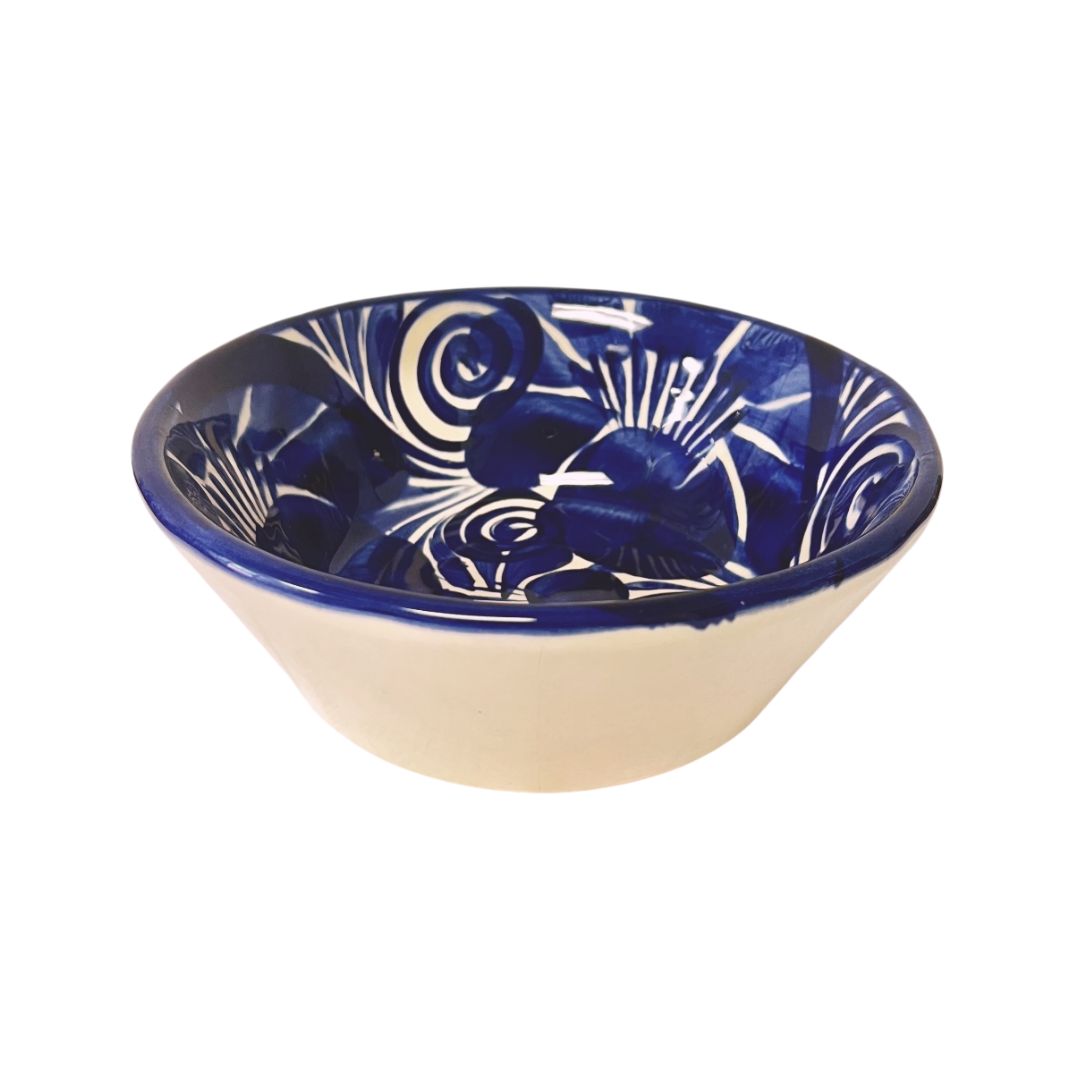 Ceramic bowl with blue and white floral pattern on a white background