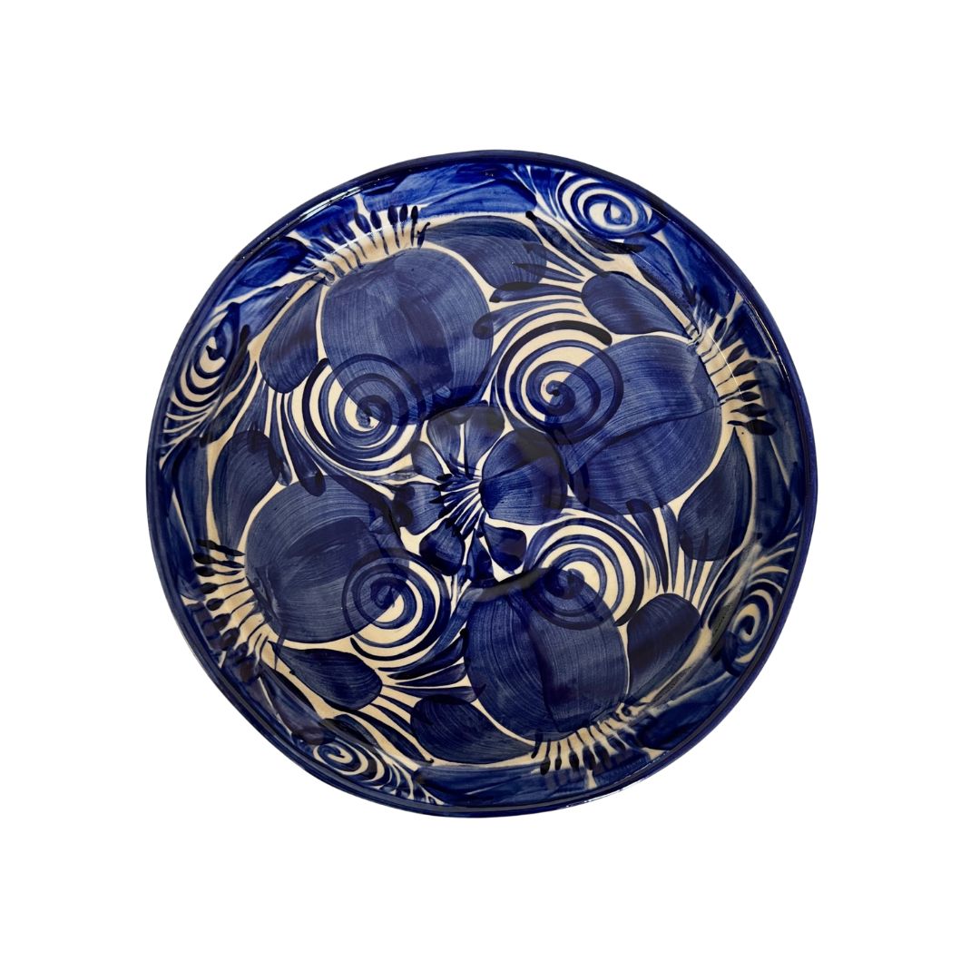 Blue ceramic plate with white floral patterns on a white background
