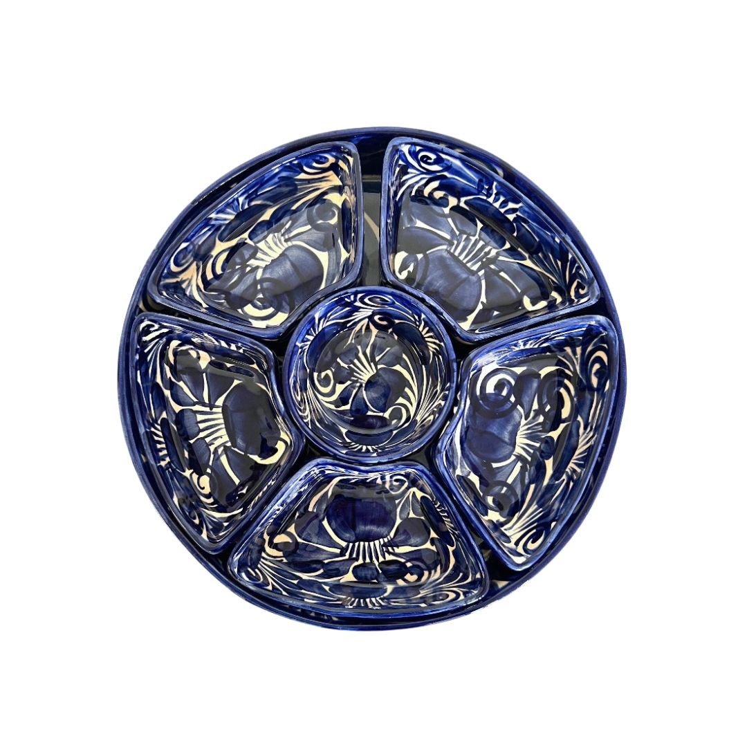 Blue glass dish with decorative patterns on a white background