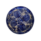 Blue ceramic plate with white floral patterns on a white background